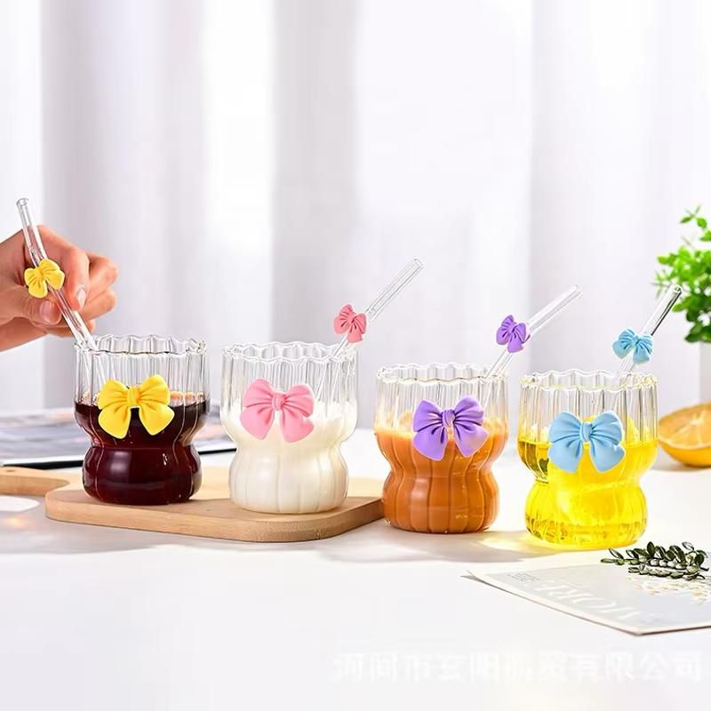 Ripple-textured glass tumbler featuring a signature 3D bow